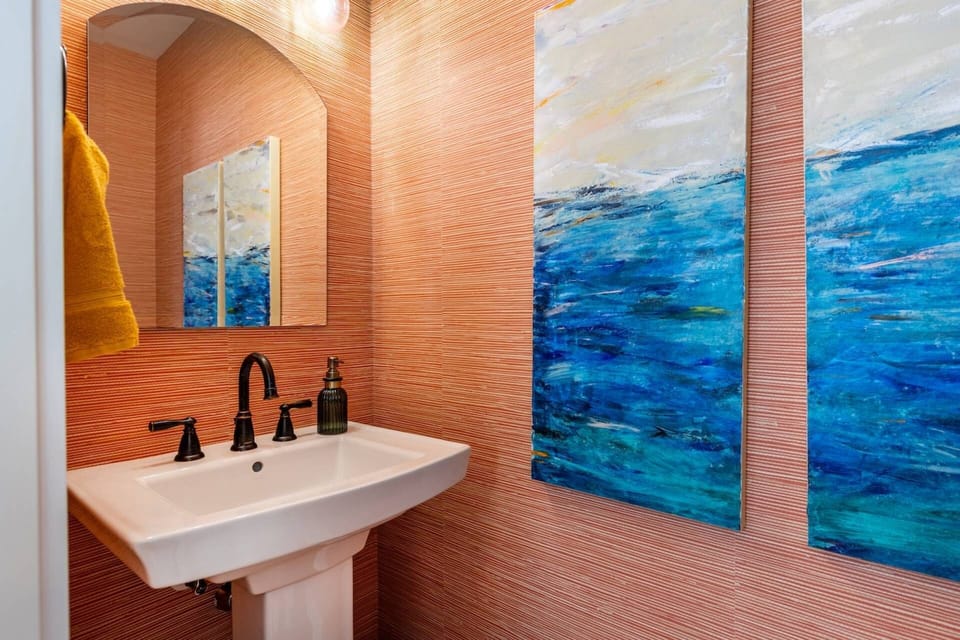 The main floor powder room is conveniently located in the Den.