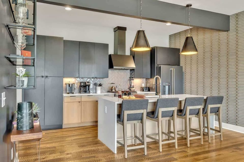 Modern sleek kitchen stocked with your basic cooking essentials. Complete with stainless steel appliances and breakfast bar seating.