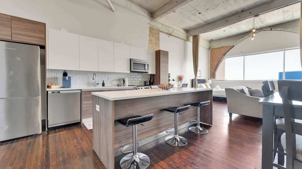 Kitchen: Modern space with chic bar seating and abundant natural light for culinary adventures!