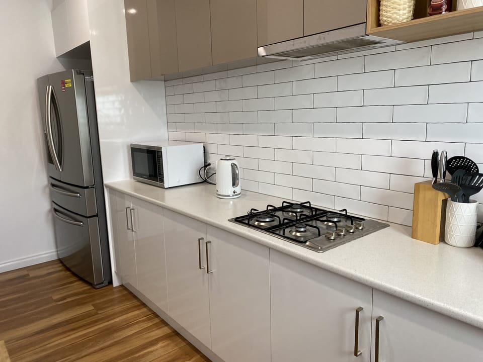 Upstairs butlers kitchen with water and ice dispenser in fridge door 