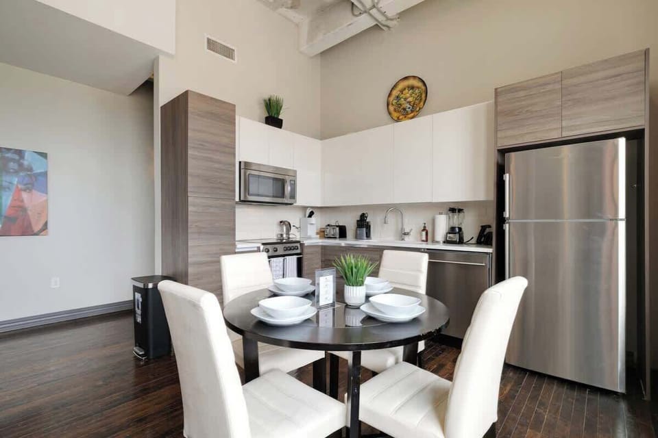 Gather around the stylish table for meals and laughter in this chic space!