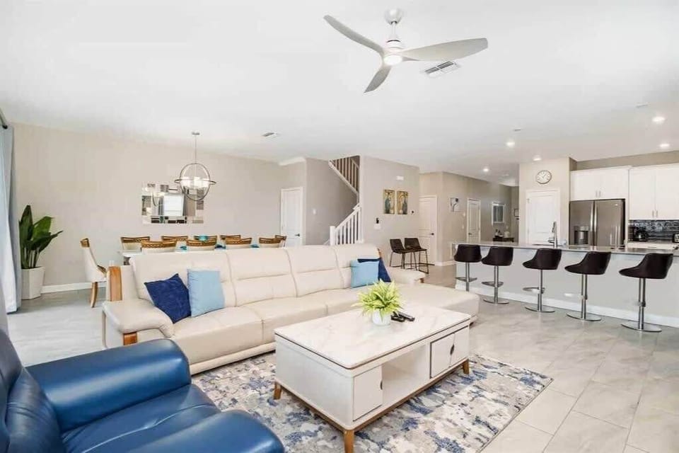 Elegant open-plan living area with ample seating, perfect for entertaining large groups in style and comfort.