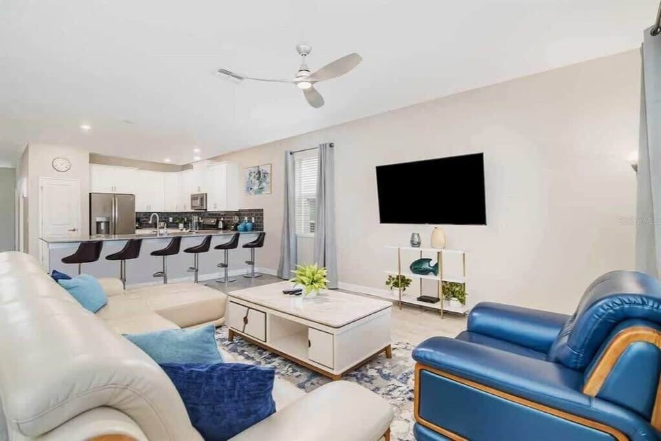 Spacious living area with modern kitchen and ample seating, ideal for entertaining and relaxation in a luxurious villa.