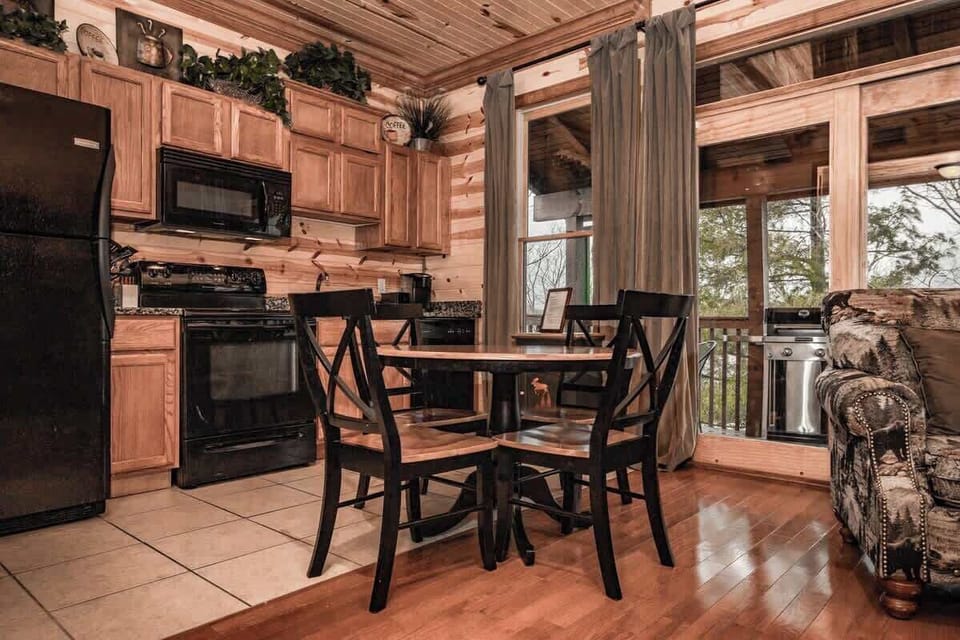 Just beyond the kitchen, you’ll find a cozy spot to gather ‘round the grill, share a meal, and soak up that good ol’ Smoky Mountain air.