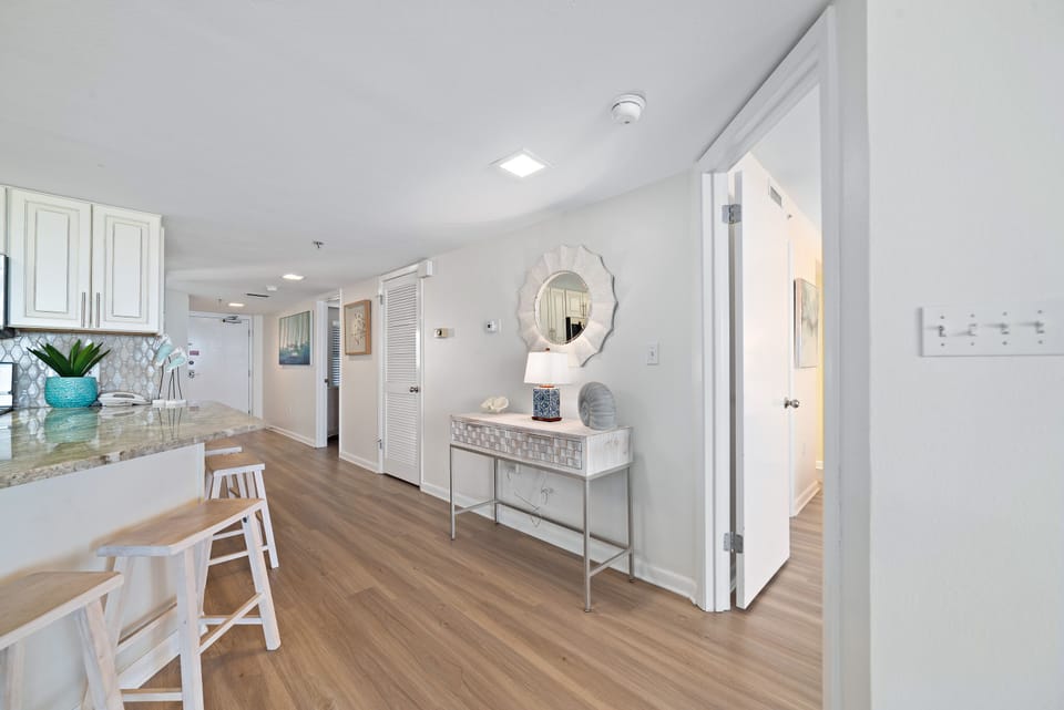 Every detail considered: a well-appointed kitchen, open dining, and a clear path to your coastal escape. Note the convenient entryway and ample storage.