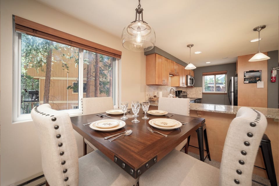 Your elegant dining space features warm wood finishes and stylish lighting, perfect for memorable meals with mountain views.
