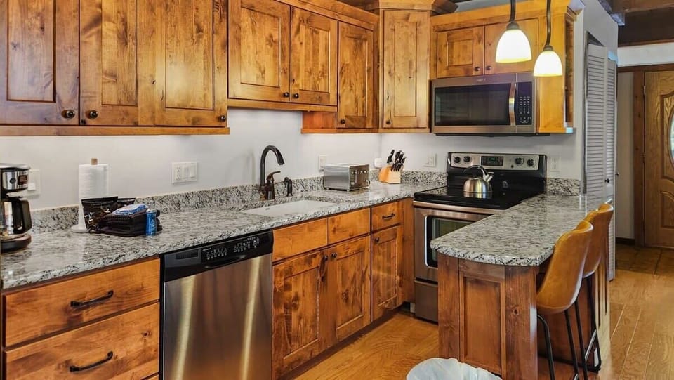 Kitchen: Drip coffee maker, Crockpot, blender, toaster, cooking utensils, tableware
