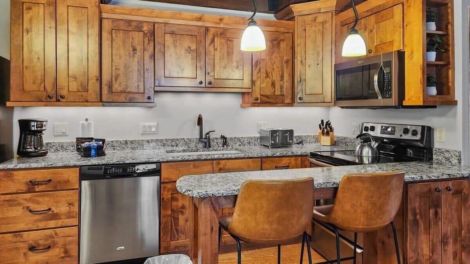 Kitchen: Drip coffee maker, Crockpot, blender, toaster, cooking utensils, tableware