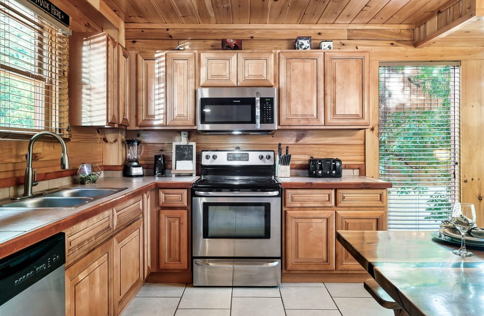A kitchen built for cooking for 24. Two coffee pots going, someone on pancakes, everyone in the way.
