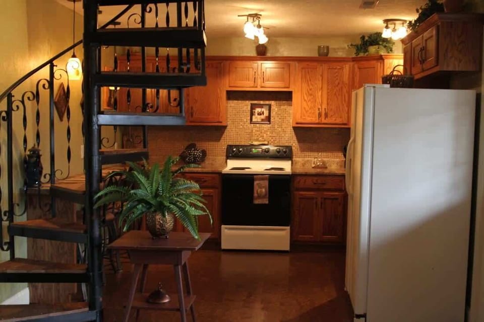 Cabin #3 Kitchen Area and spiral staircase leading to the upstairs.
