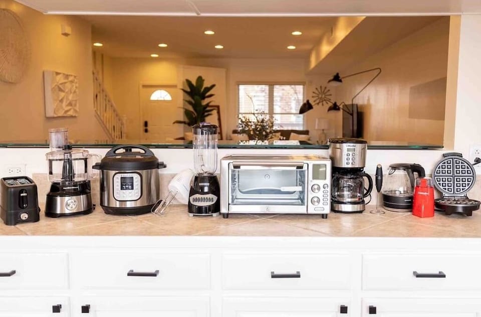 Enjoy our FULLY stocked kitchen which includes an air fryer, blender, toaster, instapot (that also functions as a slow cooker and rice cooker), waffle maker, food processor, electric mixer, electric kettle, coffee maker, and milk frother!