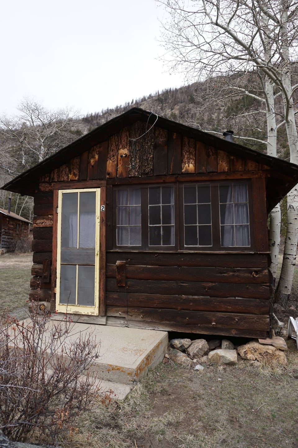Cabin 2 has a small deck and a picnic table just outside.