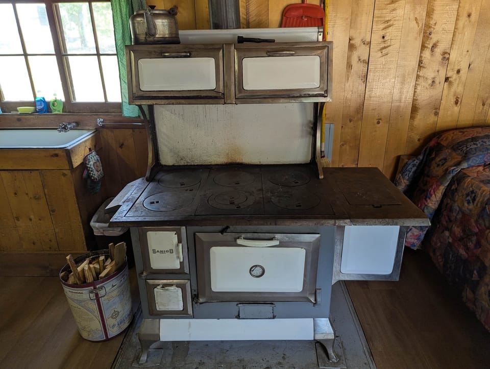 Cabin 3 is a cozy rustic cabin that features a wood-burning stove.