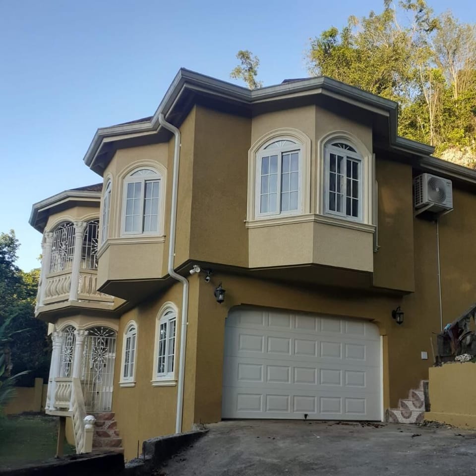 Front view of the house with parking space in front of the garage.