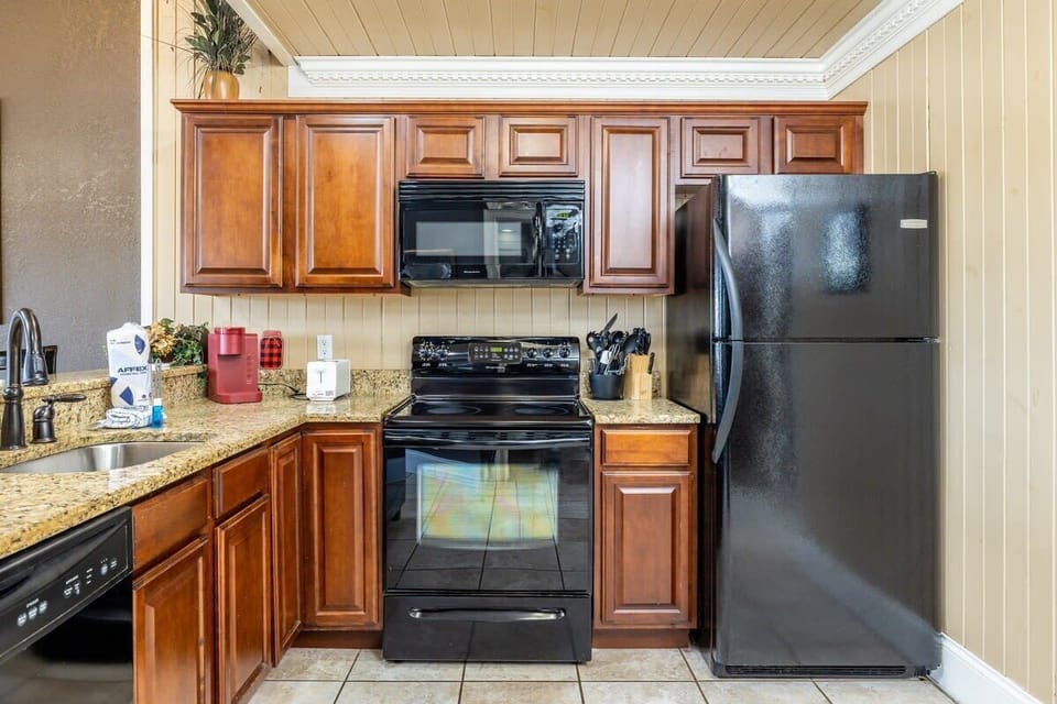 Culinary adventures await in this spacious haven with rich cabinetry and sleek appliances!