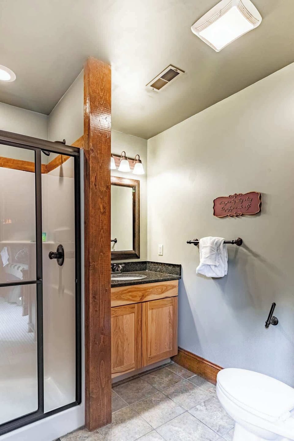 The upstairs bathroom is full - complete with a sink, toilet, and walk-in shower