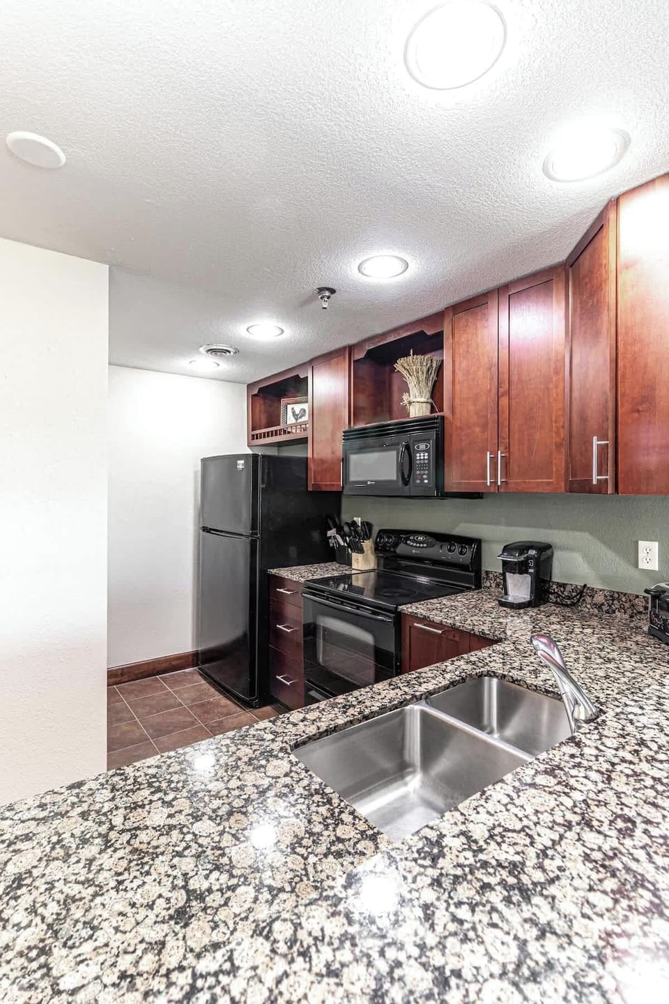 Our kitchen well-lit and full of the appliances you need