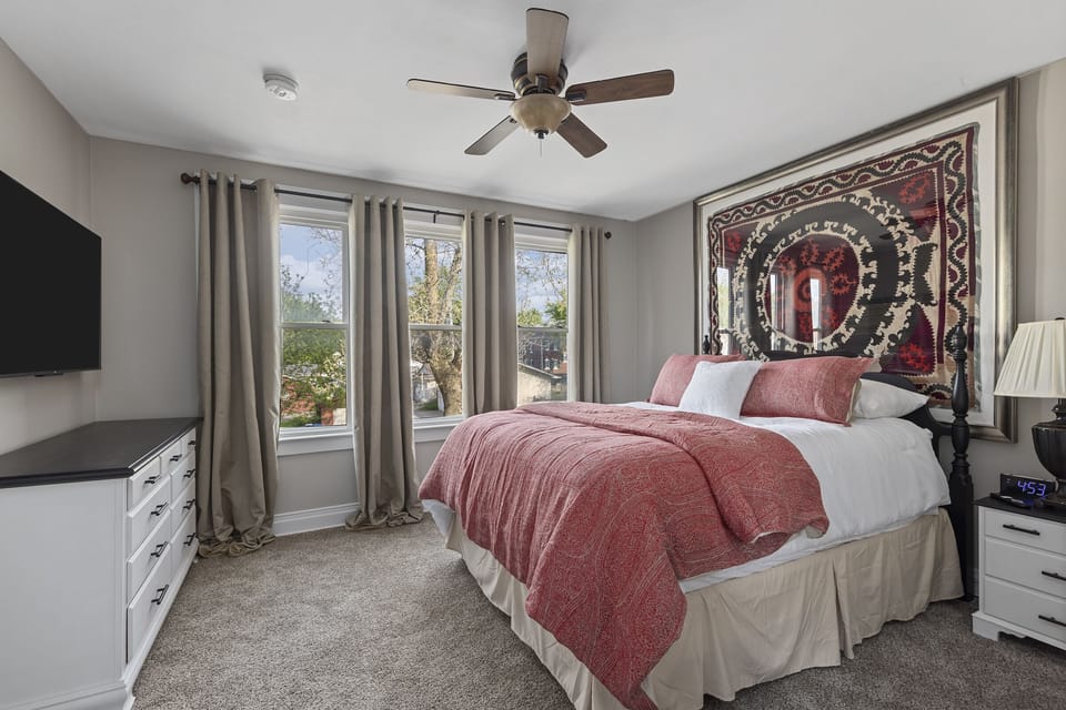 Queen bedroom with large TV