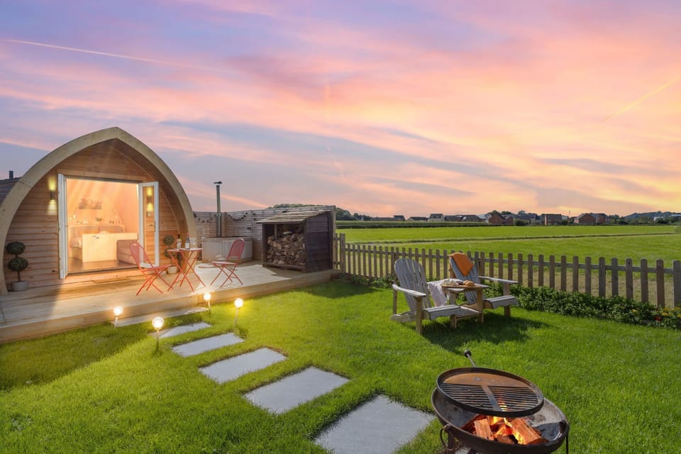 The garden at Chapterhouse with a firepit, seating and a hot tub - Chapterhouse