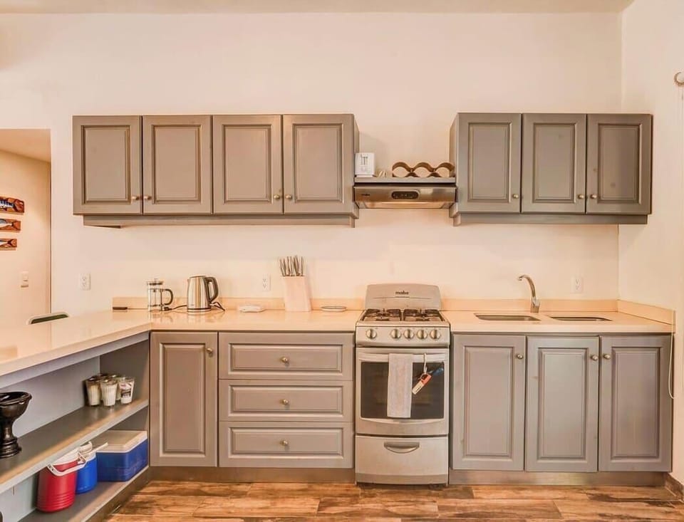 Fully equipped kitchen with a breakfast bar seating four.