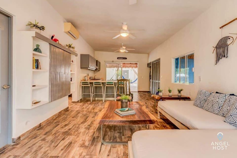 Spacious living area featuring natural wood furnishings.