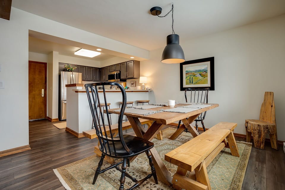 Gather around your rustic wooden dining table with cozy Windsor chairs and bench seating for memorable meals.