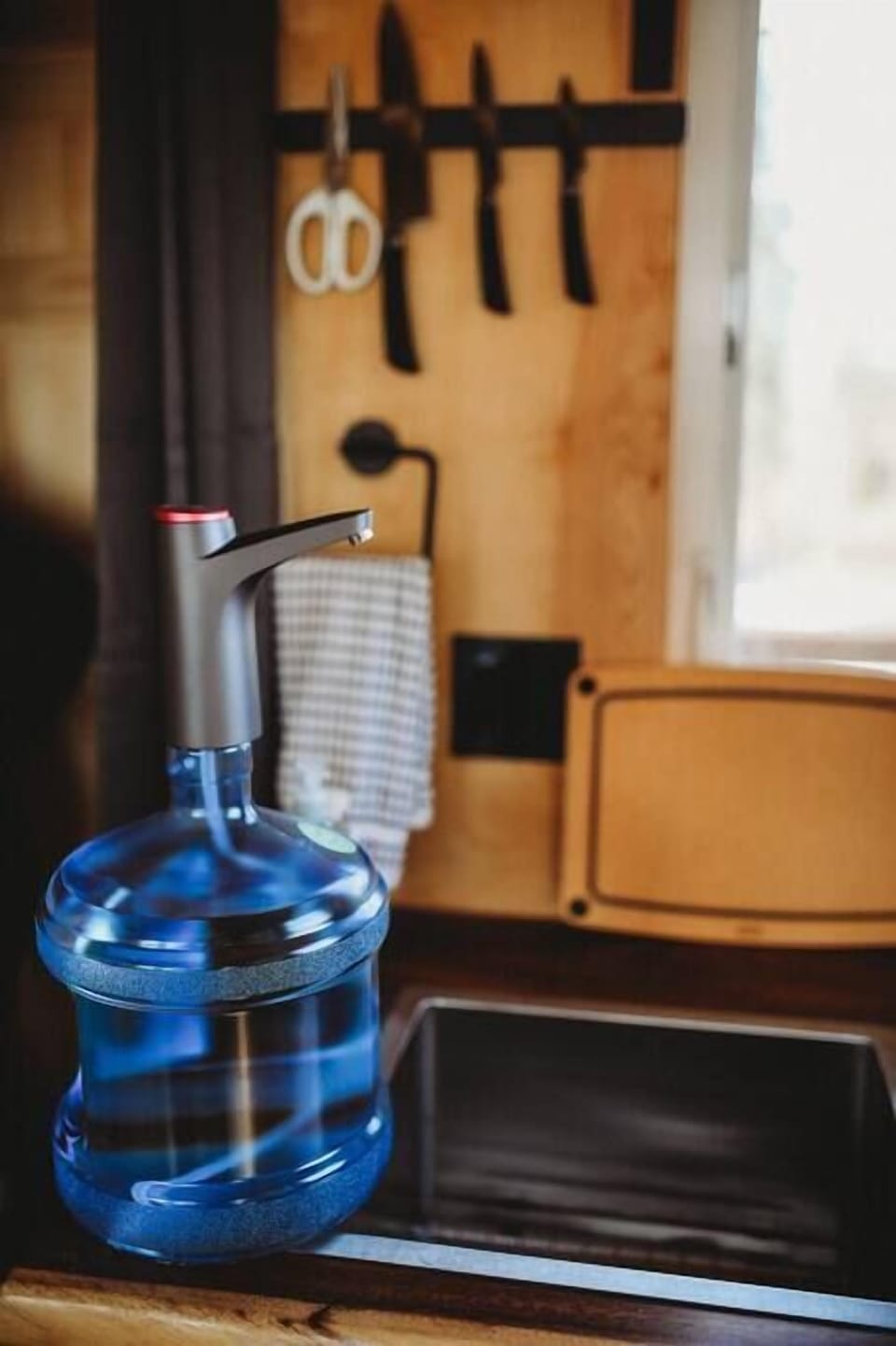 Stay refreshed with our convenient water dispenser in the cozy kitchen of your Alaskan treehouse.