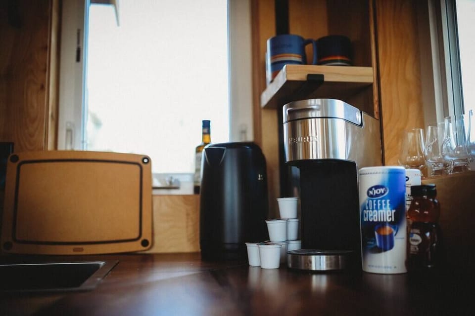 Start your day with a perfect cup of coffee from our well-equipped kitchen, featuring a coffee maker, creamers, and all the essentials for a cozy morning in Alaska.