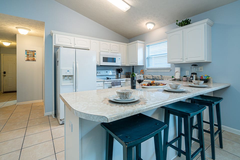 Kitchen: Whip up culinary delights at this stylishly appointed kitchen with a spacious bar!