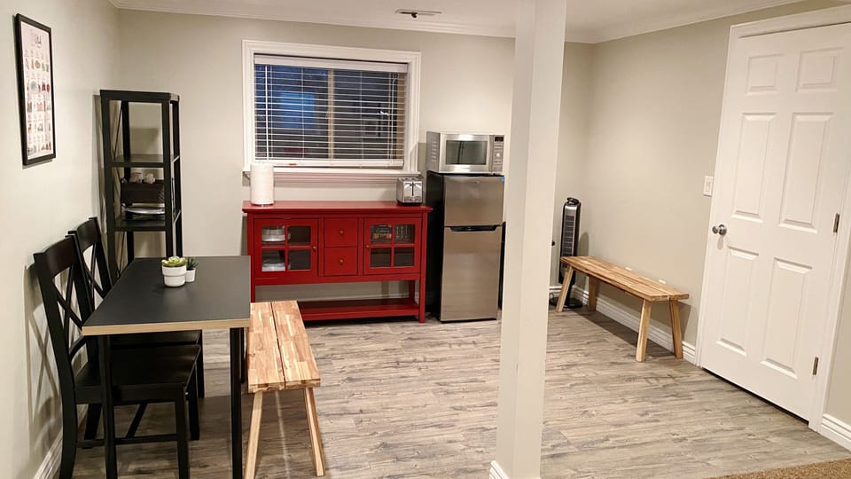 Kitchenette with microwave, toaster and refrigerator. 