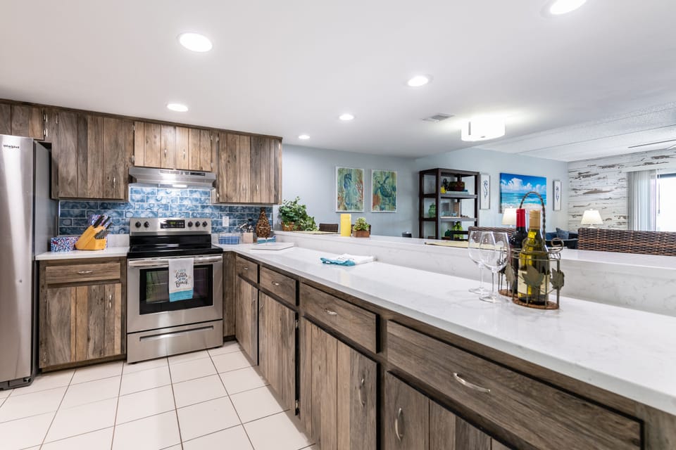 Updated kitchen. New counter tops, backsplash, lighting and appliances. 