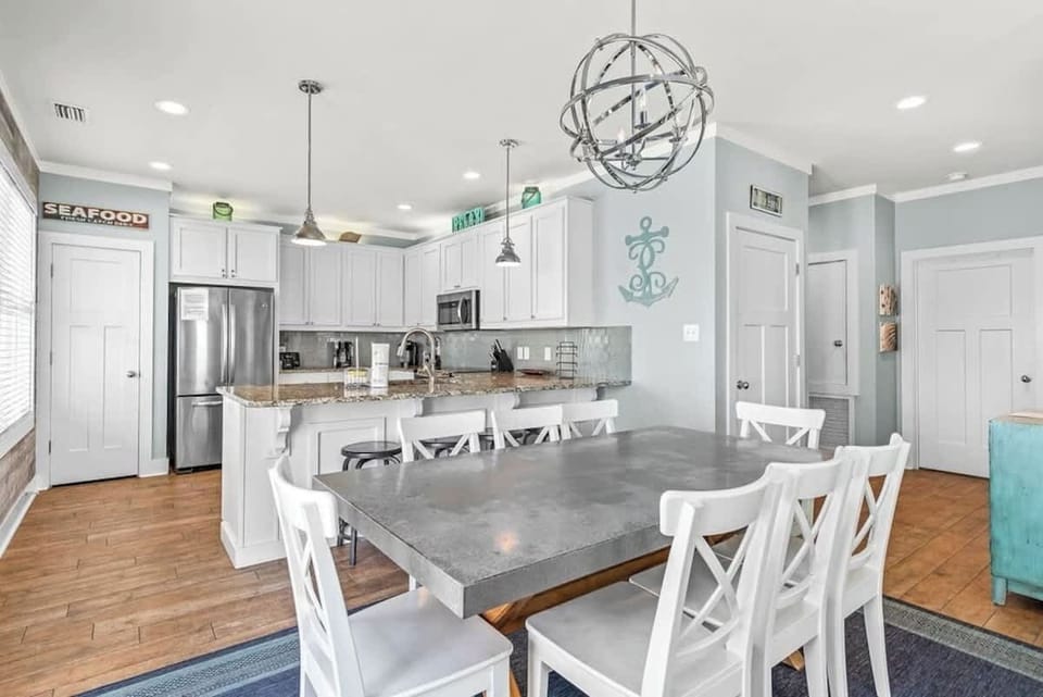 Stunning kitchen featuring an 8-seat dining table for group meals.
