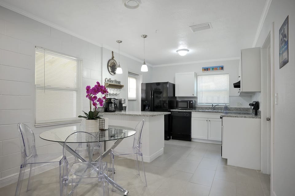 Dining table with seating for up to four is right next to the kitchen.