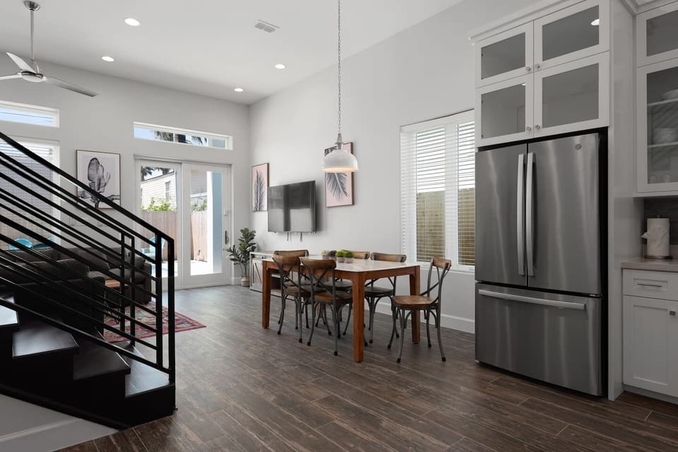 Elegant dining space beside modern kitchen and staircase