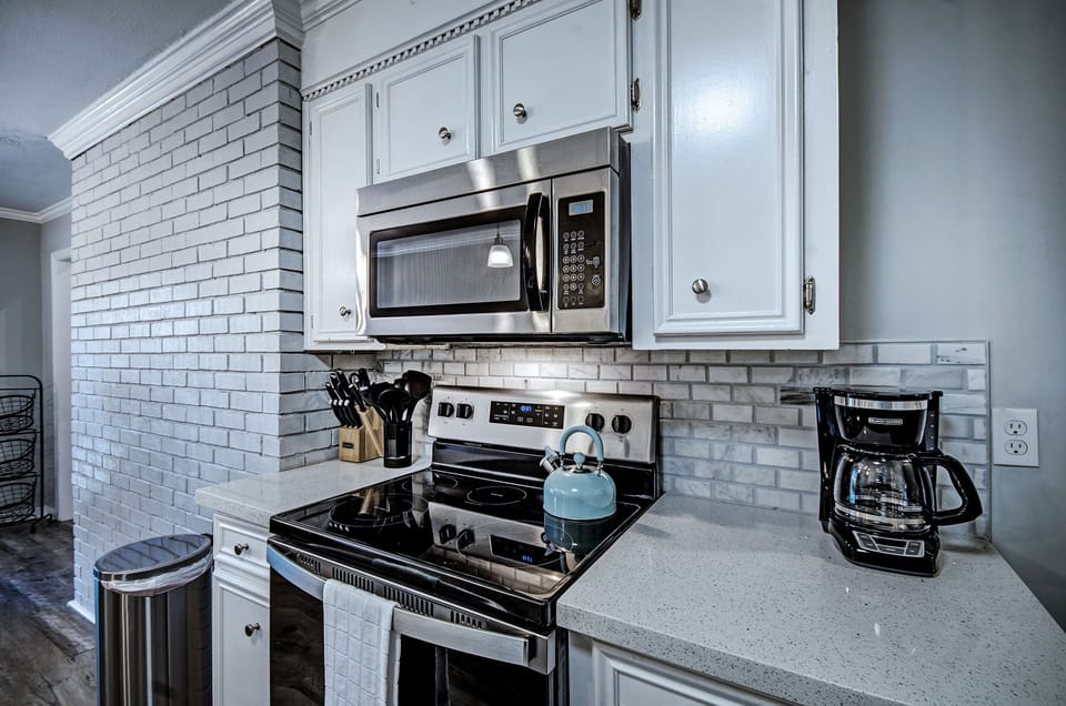 The kitchen with the 12 cup programmable coffee pot and tea kettle. 