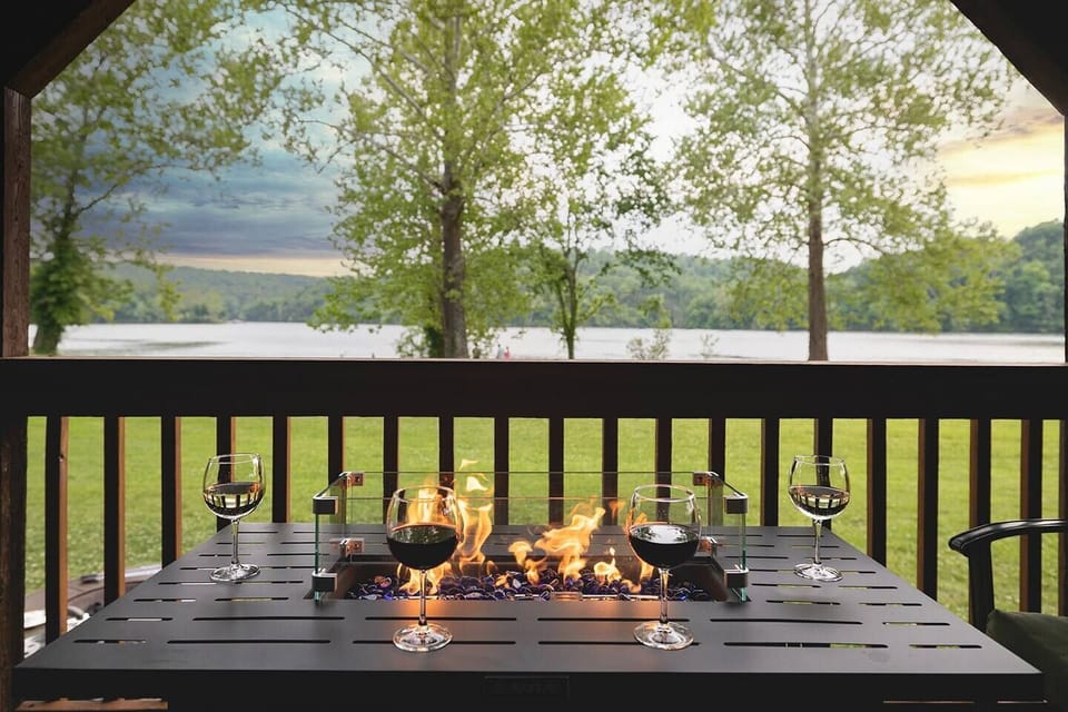Serene Lake Views from the private 50-foot deck. Enjoy meals, soaking in the hot tub, and relaxing around the fire table on this covered deck every morning and night.