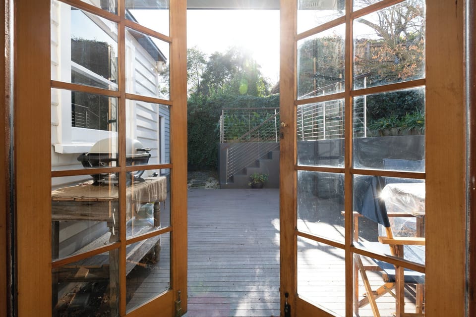 Beautiful French doors that open up onto the outdoor patio and BBQ area