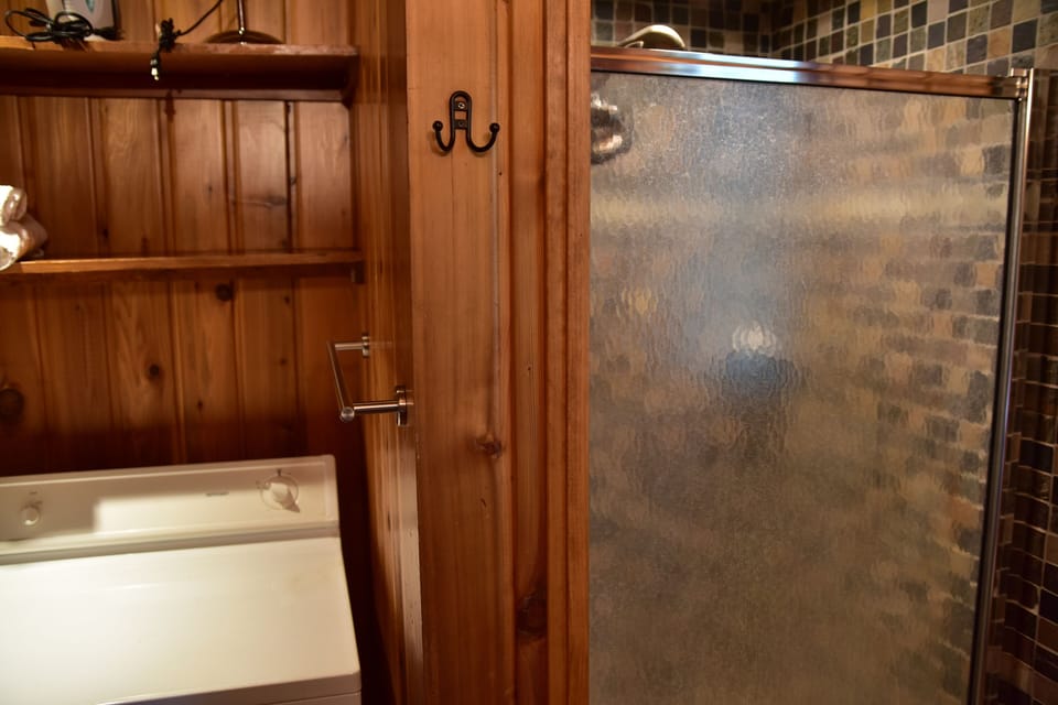 full bathroom with walk in shower at entrance level