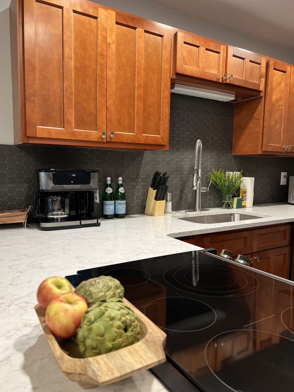 Large kitchen with quartz countertops and stainless steel appliances.