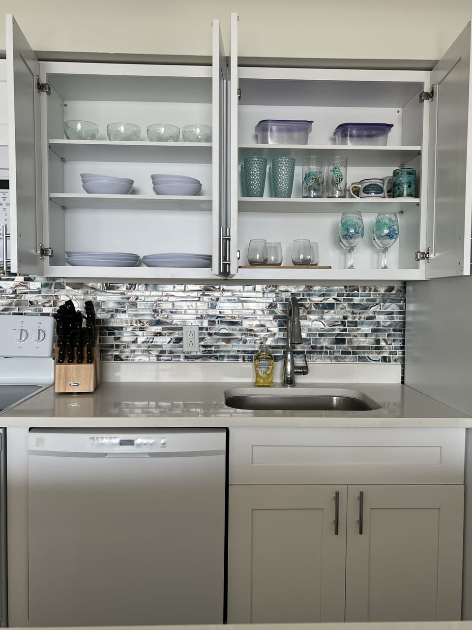 Fully stocked kitchen with new plates, glasses, knives and more