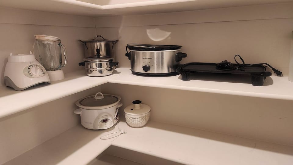 Kitchen has crockpots, rice maker, pancake grill, blender and more.