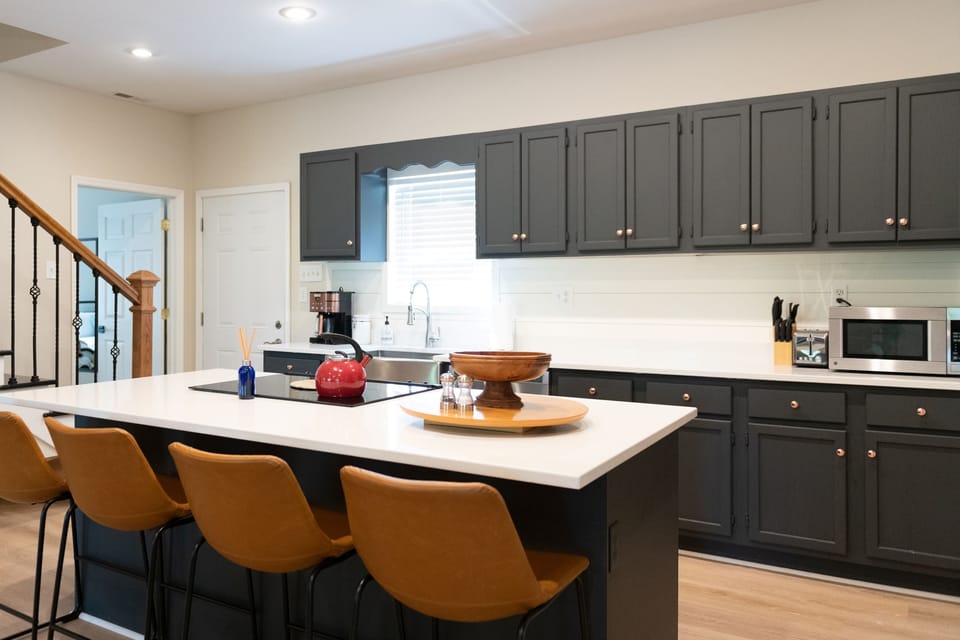 Kitchen island with stocked kitchen with everything needed to make a great meal