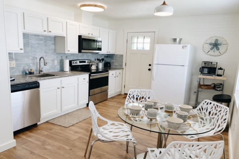 Kitchen with dining for 4 and access to back deck and outdoor shower