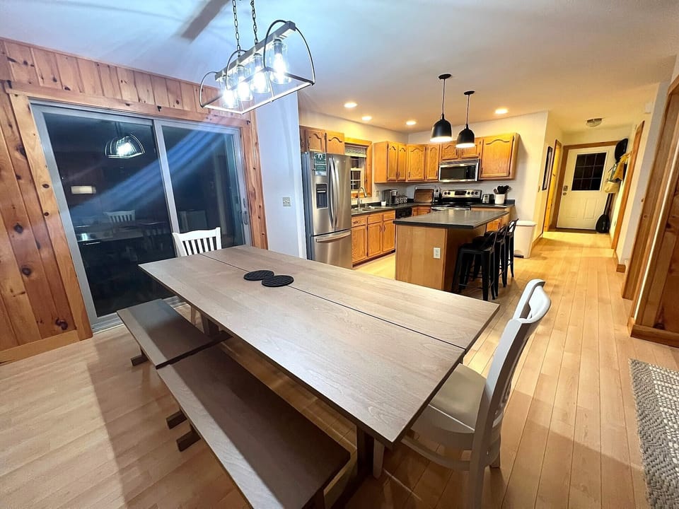 Large farm table for family meals  and games. Slider leads to second floor deck.