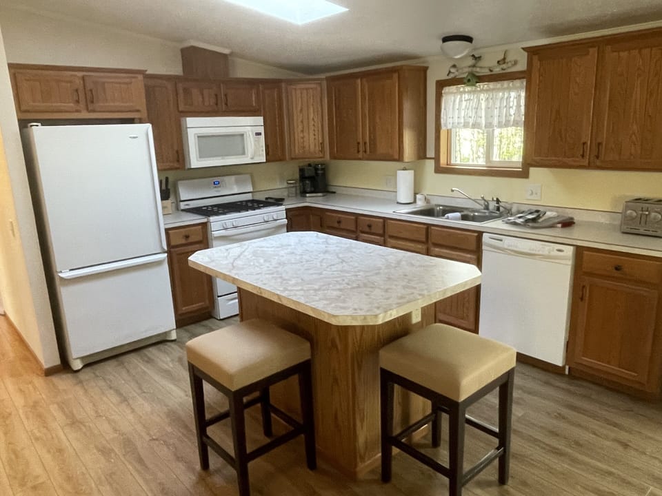 Full amenity kitchen with a coffee maker and dishwasher 