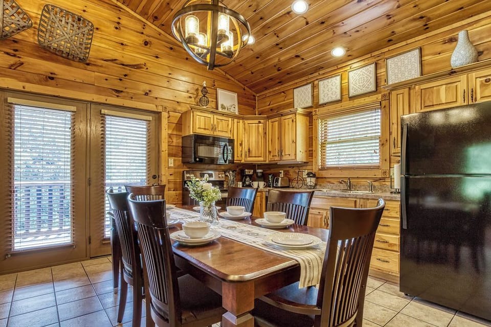 Solid wood dining table seats 6-8, newer appliances in the kitchen.