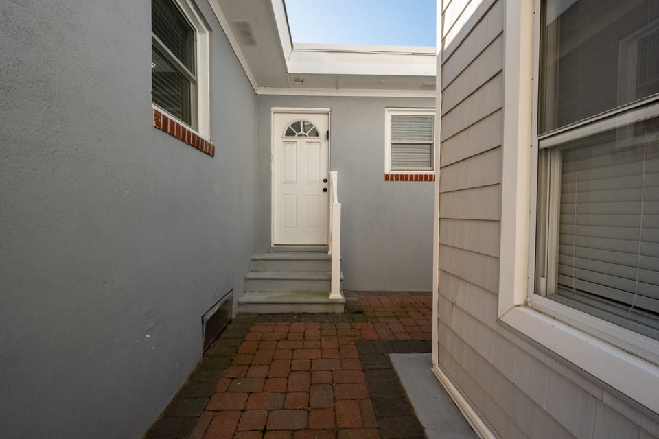 Laundry room and storage room entrance outside shower