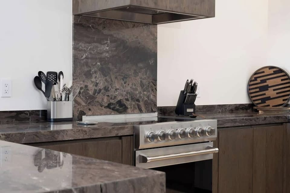 Fully equipped kitchen with natural quartzite countertops, Viking appliances, a wine fridge, dishwasher, and everything you need to enjoy a meal with your family and friends. We also offer at-home, private chef services.