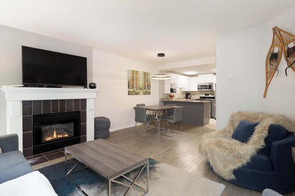 - Inviting lounge with fireplace and smart TV for cozy evenings  
- Fur-accented chairs and cabin decor add mountain charm  
- Relax indoors after a day on the slopes or trails  
