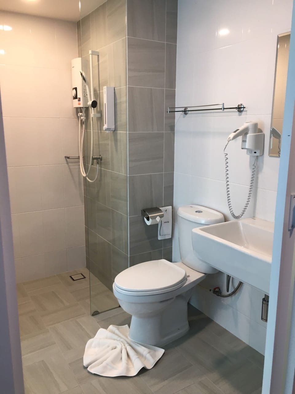 Shower, rainfall showerhead, hair dryer, towels